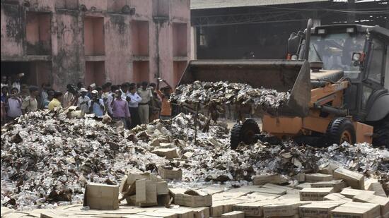 Bottles of country liquor being destroyed in Patna. (HT)