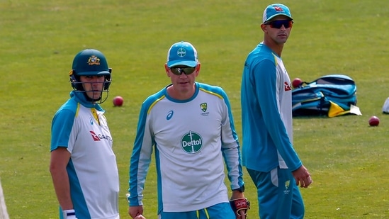 File photo - Australia's Test squad skipper Pat Cummins, left, coach Andrew McDonald, center, and Ashton Agar attend a practice session.(AP)