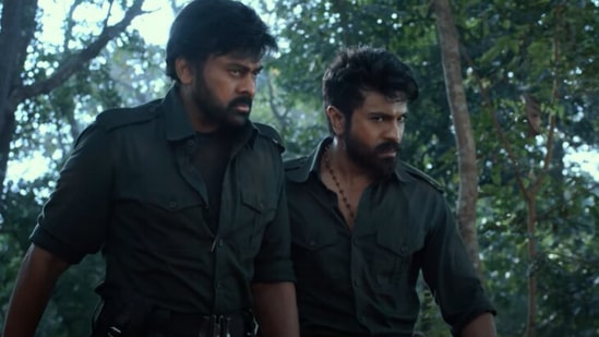 Actor Chiranjeevi and his son Ram Charan in a still from the Acharya trailer.