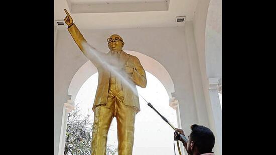 A statue of Dr BR Ambedkar in Lucknow being cleaned. (Deepak Gupta/HT Photo)