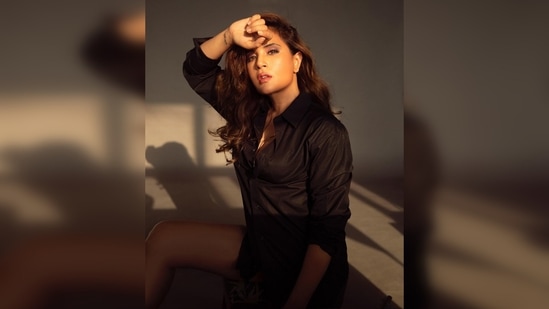 Richa Chadha lets the sun gently kiss her face as she struck some sultry poses for the camera in her black shirt.(Instagram/@richachadha)