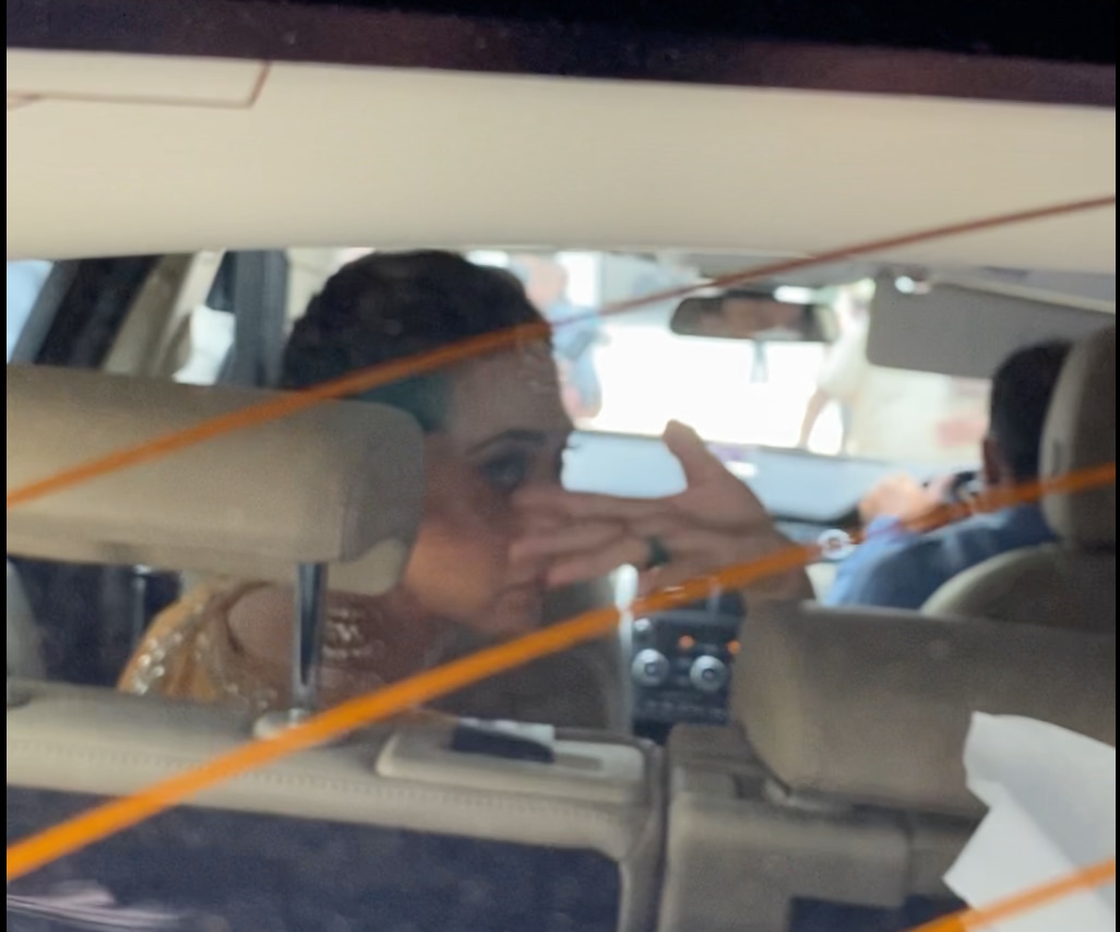 Karisma Kapoor waves from her car.