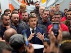 French President and liberal party La Republique en Marche (LREM) candidate for re-election Emmanuel Macron (C) addresses employees of the Siemens Gamesa wind turbines factory during his campaign visit in Le Havre, western France. French President and liberal party La Republique en Marche (LREM) candidate for re-election Emmanuel Macron (C) addresses employees of the Siemens Gamesa wind turbines factory during his campaign visit in Le Havre, western France.