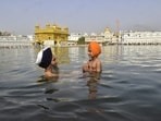 Baisakhi or Vaisakhi is one of the major festivals of Sikhs. It marks the beginning of the Sikh New Year and commemorates the formation of the Khalsa Panth of warriors under the 10th Guru of Sikh Guru Gobind Singh in 1699. On the occasion, devotees on Thursday took a holy dip and offered prayers at the Golden Temple.(HT Photo/Sameer Sehgal)