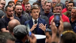 French President and liberal party La Republique en Marche (LREM) candidate for re-election Emmanuel Macron (C) addresses employees of the Siemens Gamesa wind turbines factory during his campaign visit in Le Havre, western France.
