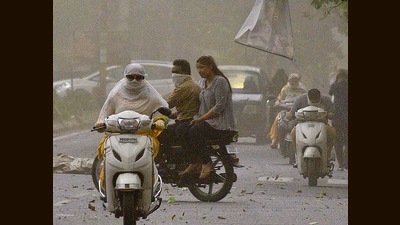 Commuters brave the gusty wind in Ludhiana on Thursday. (Gurpreet Singh/HT)