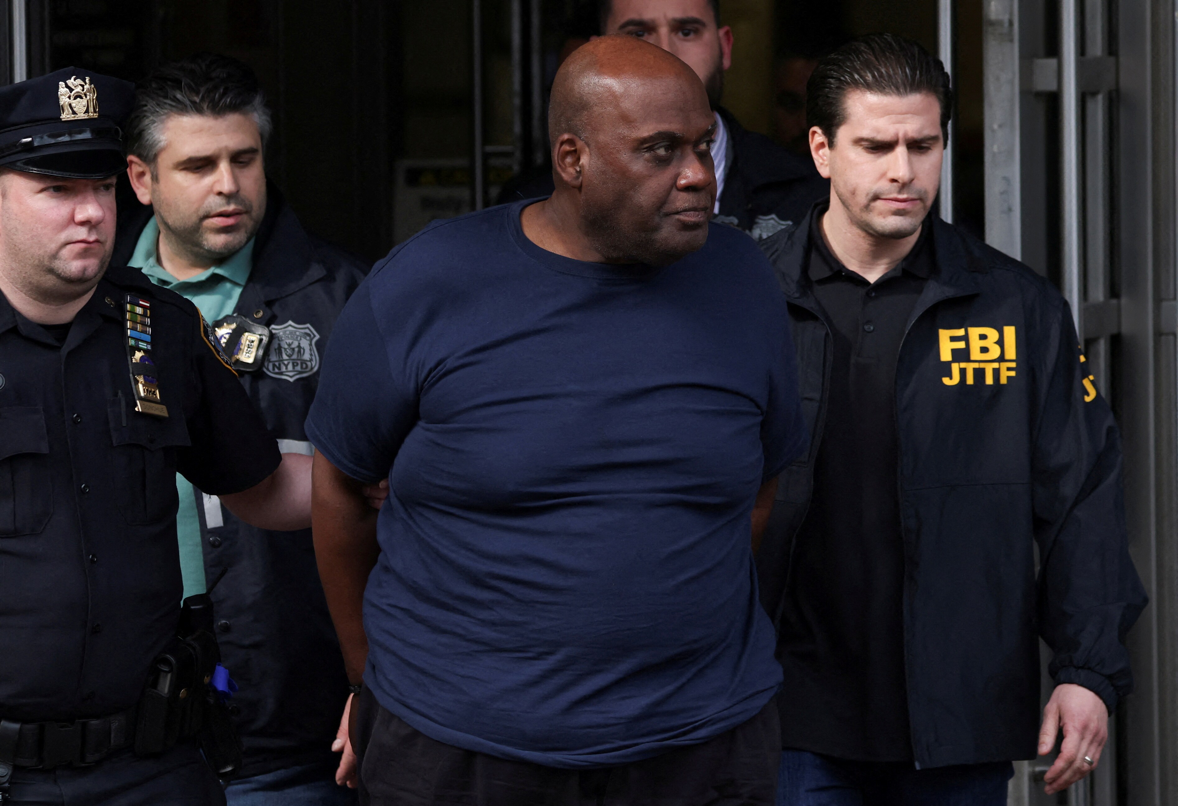 Frank James, the suspect in the Brooklyn subway shooting walks outside a police precinct in New York City, New York, US, April 13, 2022. (REUTERS/Andrew Kelly)