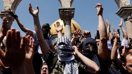 Palestinians shout slogans at the compound that houses Al-Aqsa Mosque, following clashes with Israeli security forces in Jerusalem's Old City on April 15, 2022. & nbsp;