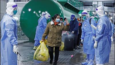 Discharged patients leave the National Exhibition and Convention Center, which has been converted into a makeshift hospital for Covid-19), in Shanghai, China, on Thursday.. (REUTERS) Discharged patients leave the National Exhibition and Convention Center, which has been converted into a makeshift hospital for Covid-19), in Shanghai, China, on Thursday.. (REUTERS)