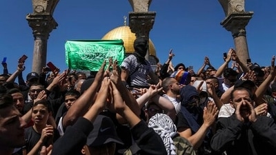 Palestinians chant slogans and wave Hamas flags during a protest against Israel, in front of the Dome of the Rock shrine at the Al Aqsa Mosque compound in Jerusalem's Old City. (AP) Palestinians chant slogans and wave Hamas flags during a protest against Israel, in front of the Dome of the Rock shrine at the Al Aqsa Mosque compound in Jerusalem's Old City. (AP)