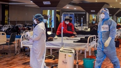 COVID-19 patients undergo treatment inside the Shehnai Banquet Hall, a COVID-19 care facility, in New Delhi,(PTI Photo/Kamal Singh) (PTI) COVID-19 patients undergo treatment inside the Shehnai Banquet Hall, a COVID-19 care facility, in New Delhi,(PTI Photo/Kamal Singh) (PTI)