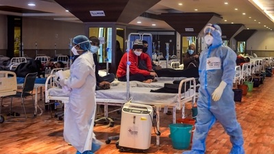 Covid-19 patients undergo treatment inside the Shehnai Banquet Hall, a Covid-19 care facility, in New Delhi. (PTI) Covid-19 patients undergo treatment inside the Shehnai Banquet Hall, a Covid-19 care facility, in New Delhi. (PTI)
