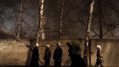 Firefighters extinguish a fire at a factory after a Russian attack. (File photo) (AP)