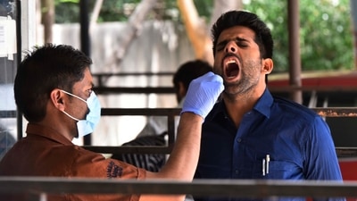 A health worker collects a swab sample for the RT-PCR Covid-19 test.