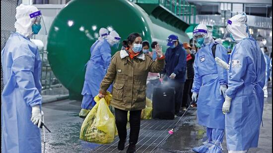 Discharged patients leave the National Exhibition and Convention Center, which has been converted into a makeshift hospital for Covid-19), in Shanghai, China, on Thursday.. (REUTERS)