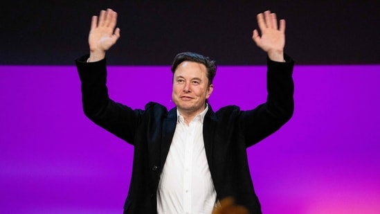 Tesla chief Elon Musk waving onstage at the TED2022.(AFP)