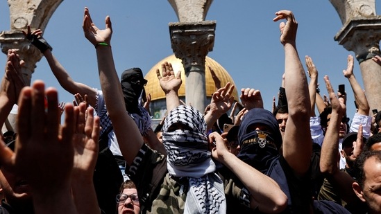 Palestinians shout slogans at the compound that houses Al-Aqsa Mosque, following clashes with Israeli security forces in Jerusalem's Old City on April 15, 2022.&nbsp;(REUTERS)