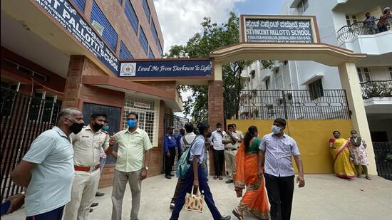 Bengaluru: Police and parents outside a school, where the school authorities received a bomb hoax mail, in Bengaluru, Friday, April 8, 2022. Bengaluru City Police Commissioner Kamal Pant on Friday said seven schools in the city have received bomb threat through e-mail and police teams are at the spot conducting checks. (PTI Photo)(PTI04_08_2022_000135B) (PTI)