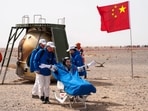In this photo released by China's Xinhua News Agency, Chinese astronaut Ye Guangfu sits outside return capsule of the Shenzhou-13 manned space mission after landing at the Dongfeng landing site in northern China's Inner Mongolia Autonomous Region, Saturday.(AP)