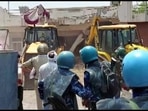 Khargone administration demolishing the properties of the accused in communal clashes during the Ram Navami procession.
