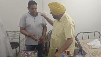 Dera Bassi MLA Kuljit Randhawa with suspended cop Gulshan Kumar at the Mubarakpur police post. (HT Photo)