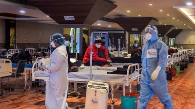 Covid-19 patients undergo treatment inside the Shehnai Banquet Hall, a Covid-19 care facility, in New Delhi. (PTI) Covid-19 patients undergo treatment inside the Shehnai Banquet Hall, a Covid-19 care facility, in New Delhi. (PTI)