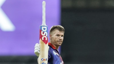 Mumbai: David Warner of Delhi Capitals raises his bat after scoring a fifty during the Indian Premier League 2022 cricket match between Delhi Capitals and Royal Challengers Bangalore, at the Wankhede Stadium, in Mumbai, Saturday, April 16, 2022. (Sportzpics/PTI Photo) (PTI04_16_2022_000321B) (PTI) Mumbai: David Warner of Delhi Capitals raises his bat after scoring a fifty during the Indian Premier League 2022 cricket match between Delhi Capitals and Royal Challengers Bangalore, at the Wankhede Stadium, in Mumbai, Saturday, April 16, 2022. (Sportzpics/PTI Photo) (PTI04_16_2022_000321B) (PTI)