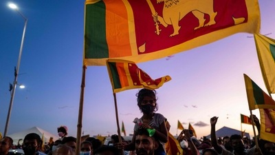 A man carrying a child on his shoulders joins others in an ongoing anti-government demonstration near the president's office in Colombo. (AFP) A man carrying a child on his shoulders joins others in an ongoing anti-government demonstration near the president's office in Colombo. (AFP)