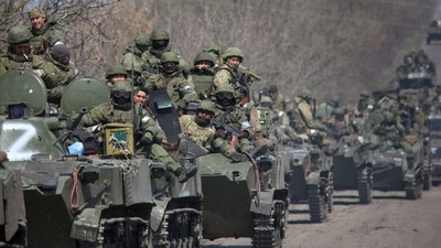 Service members of pro-Russian troops ride on armoured vehicles in the course of Ukraine-Russia conflict on a road leading to the city of Mariupol. (REUTERS)