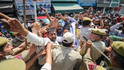 Cops trying to stop members of Civil Safaikaramchari Union during their protest march towards the residence of J&K lieutenant governer, in Jammu on Saturday. (PTI)