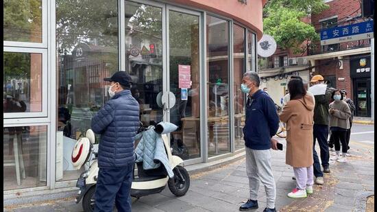 People wait in line to buy bread at a bakery and pastry shop, as the city eases the lockdown in some areas, amid Covid-19 outbreak in Shanghai, China,on Saturday. (REUTERS) People wait in line to buy bread at a bakery and pastry shop, as the city eases the lockdown in some areas, amid Covid-19 outbreak in Shanghai, China,on Saturday. (REUTERS)