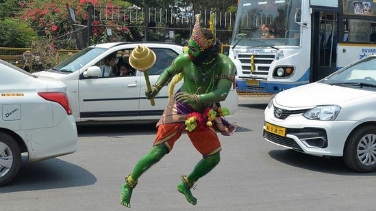 An artist dressed as Hanuman dances in the street in Bangalore, Karnartaka. (Manjunath Kiran / AFP)