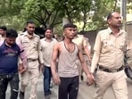 Police personnel taking the accused in the Jahangirpuri violence case to Rohini court in New Delhi on Sunday.&nbsp;