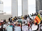 Sri Lankan demonstrators holding placards attend a protest to demand justice.(REUTERS)