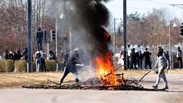 People burn branches to block a road during a riot in Norrkoping, Sweden.
