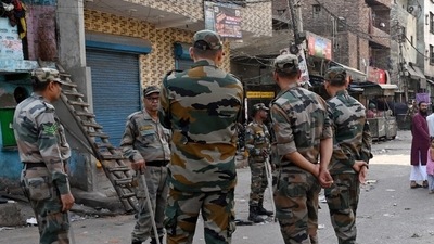 Paramilitary personnel stand guard at a site where violence broke out between two communities during the Shobha Yatra procession on Hanuman Jayanti, at Jahangirpuri, in New Delhi on Sunday. (ANI Photo) Paramilitary personnel stand guard at a site where violence broke out between two communities during the Shobha Yatra procession on Hanuman Jayanti, at Jahangirpuri, in New Delhi on Sunday. (ANI Photo)