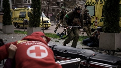 Ukrainian servicemen run for cover as explosions are heard during a Russian attack in downtown Kharkiv. (AP)