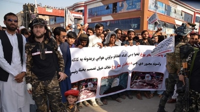Demonstrators hold a banner during a protest against Pakistani airstrikes, in Khost on Friday. (AFP)