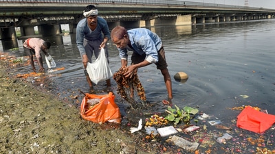 Local divers take out the 'puja' offerings thrown by devotees as they clean the Yamuna river, after the end of Navratri festival, at ITO Yamuna ghat, in New Delhi. (PTI) Local divers take out the 'puja' offerings thrown by devotees as they clean the Yamuna river, after the end of Navratri festival, at ITO Yamuna ghat, in New Delhi. (PTI)