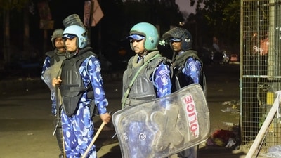 Rapid Action Force personnel guard after violent clashes broke out during a Hanuman Jayanti procession at Jahangir Puri, in New Delhi. (PTI) Rapid Action Force personnel guard after violent clashes broke out during a Hanuman Jayanti procession at Jahangir Puri, in New Delhi. (PTI)