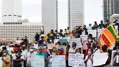 Sri Lankan demonstrators holding placards attend a protest to demand justice. (REUTERS)