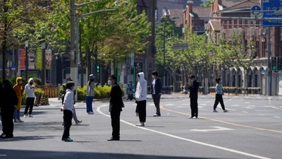 Residents stand on a street waiting for nucleic acid test during lockdown amid the coronavirus disease (COVID-19) pandemic, in Shanghai, China, (Reuters)