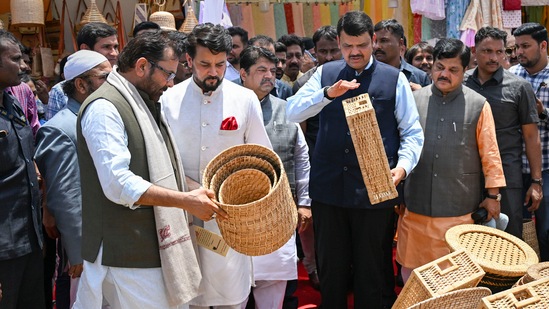 Union ministers Anurag Thakur and Mukhtar Abbas Naqvi with former Maharashtra CM Devendra Fadnavis at a stall during the inauguration of 'Hunar Haat' in Mumbai. (PTI)