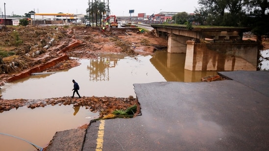 A man walks around a damaged bridge caused by flooding in Umlazi near Durban, South Africa,(Reuters)