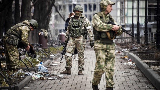 Russian soldiers walks along a street in Mariupol on April 12, 2022. (Photo by Alexander NEMENOV / AFP) (AFP)