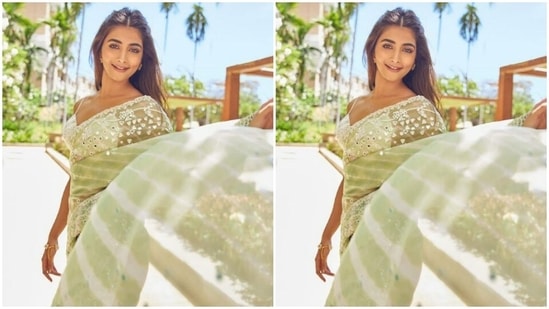 Pooja’s pastel green saree came decorated at the borders in white threads and silver mirror work is absolutely gorgerous (Instagram/@hegdepooja)