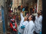 Forensic team investigate, after clashes broke out between two communities during a Hanuman Jayanti procession on Saturday, at Jahangirpuri in New Delhi, Monday.