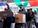 Travelers line up wearing protective masks indoors at O'Hare International Airport in Chicago.(AP) Travelers line up wearing protective masks indoors at O'Hare International Airport in Chicago.(AP)