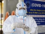 A health worker shows the collected swab sample for Reverse transcription-polymerase chain reaction (RT-PCR) for coronavirus test at the Ayushman Bharat Health and Wellness Centre in Gurugram.&nbsp;