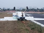 A training aircraft toppled over during landing at the Jakkur Aerodrome in Bengaluru on Sunday evening. One person sustained injuries while the other escaped unhurt, said police. A training aircraft toppled over during landing at the Jakkur Aerodrome in Bengaluru on Sunday evening. One person sustained injuries while the other escaped unhurt, said police.